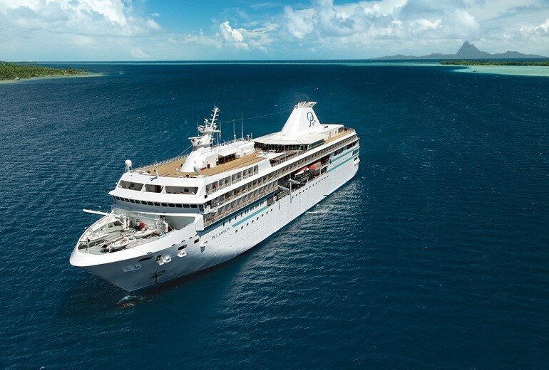 A cruise ship floats on blue water