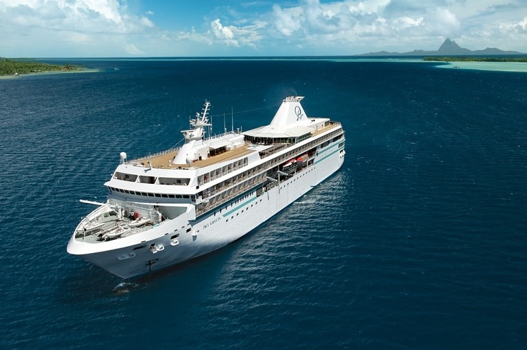 A cruise ship floats on blue water