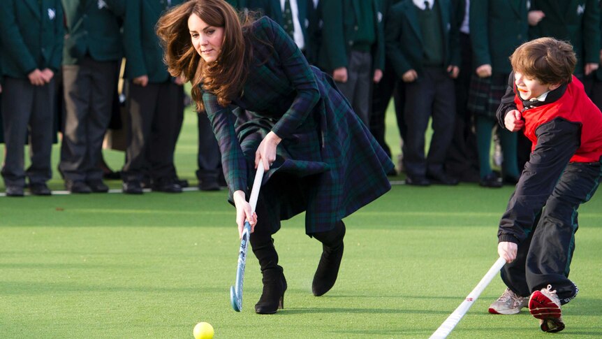 Catherine, Duchess of Cambridge, plays hockey during a visit to her old school in Pangbourne.