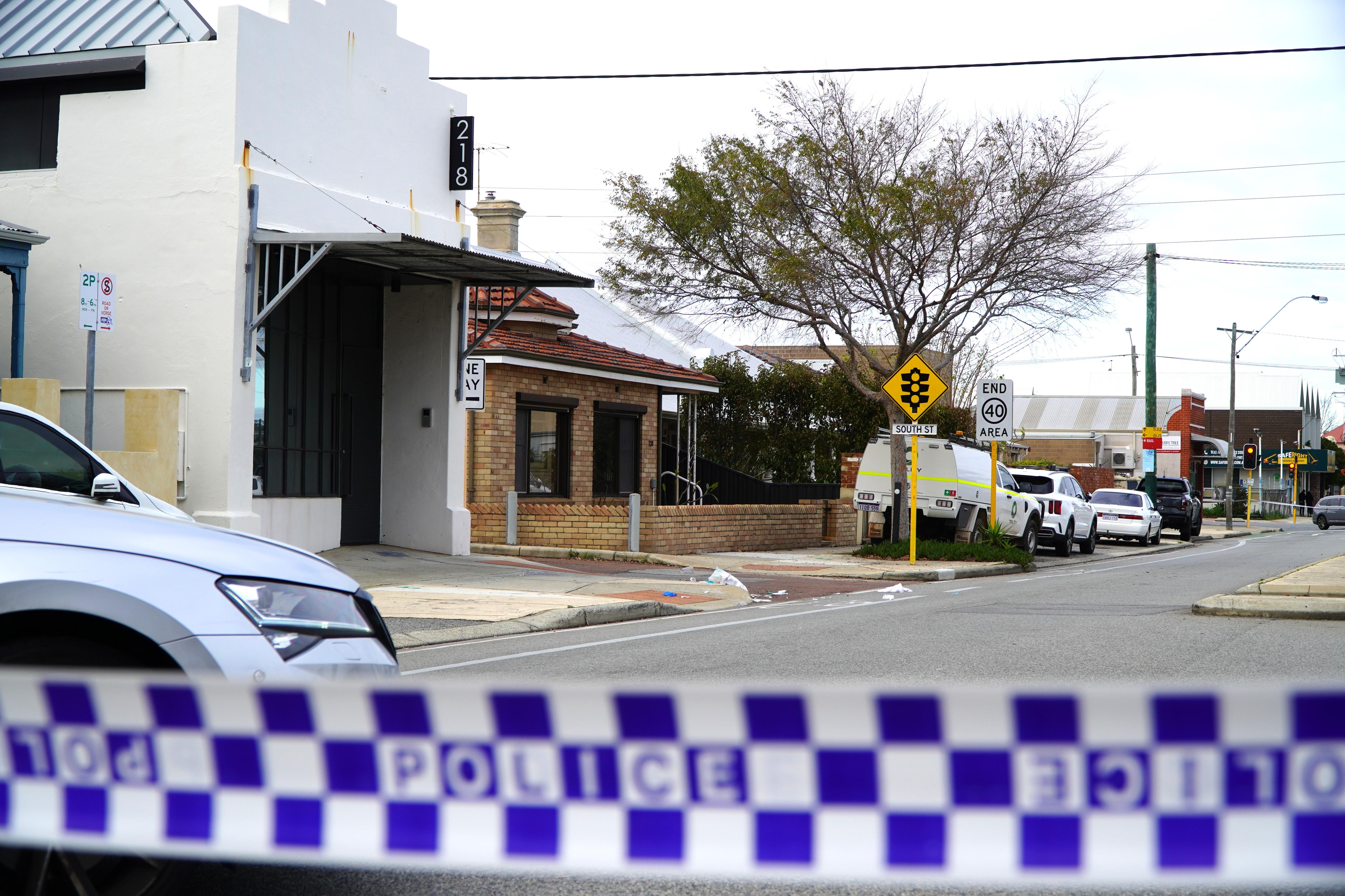 Police tape is seen cordoning off certain area in a street. 