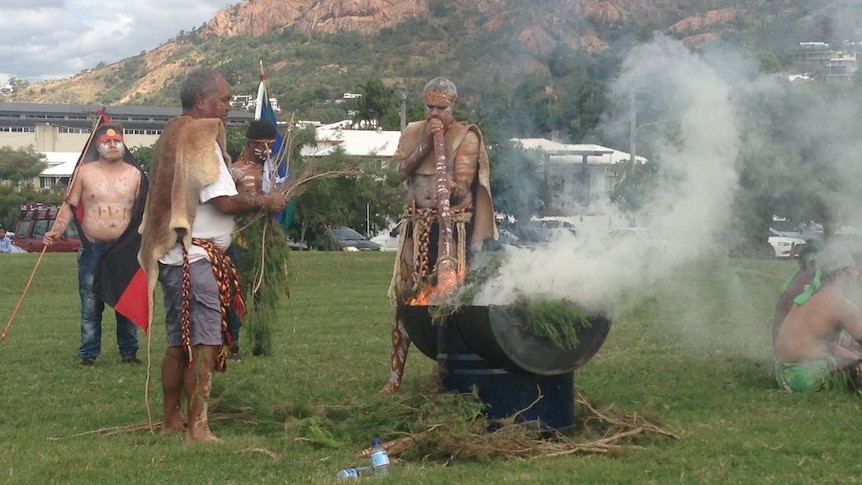 Indigenous men perform a smoking ceremony in Townsville