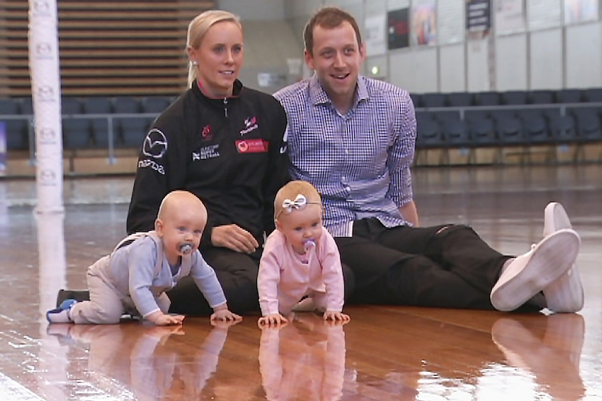 Renae and Joe Ingles sit on the floor with their twins.