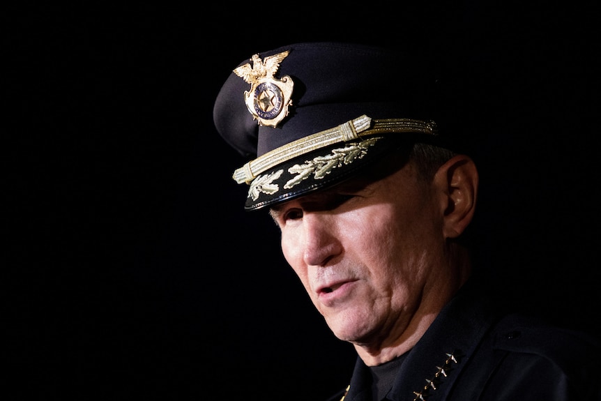 Close up face of police chief William McManus with black background.