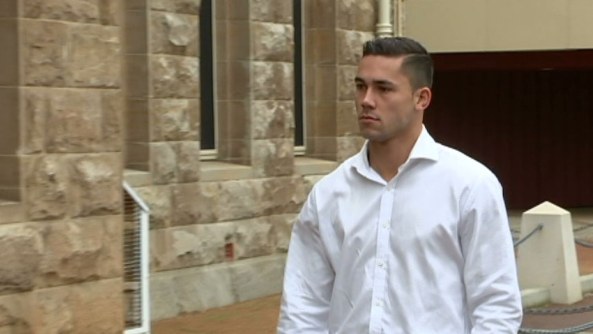 A young man in a white collared shirt outside the Perth Supreme Court building.