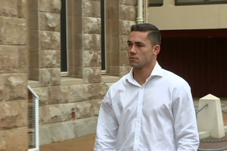 A young man in a white collared shirt outside the Perth Supreme Court building.