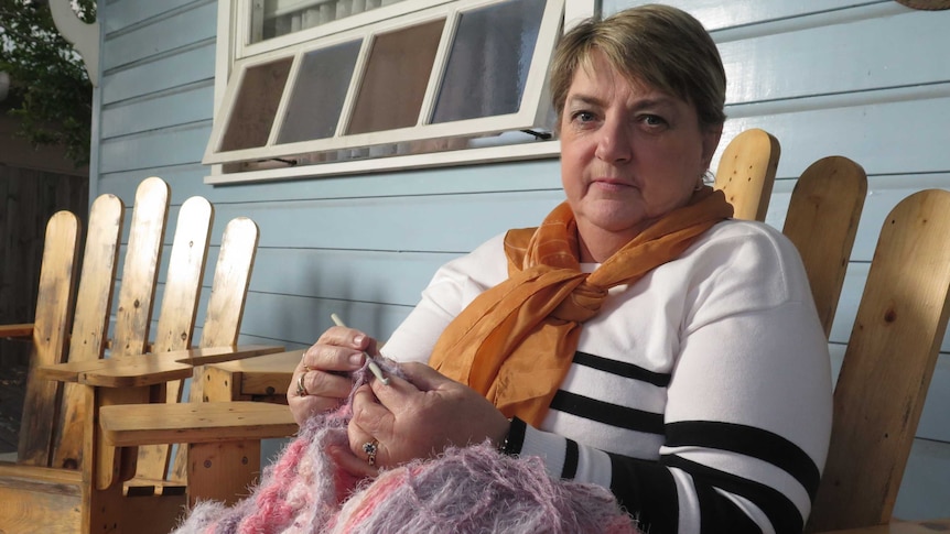 Debbie Thompson knitting on her veranda