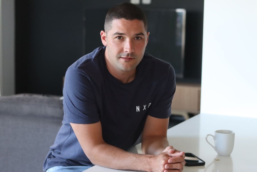 A portrait of a man standing in a kitchen