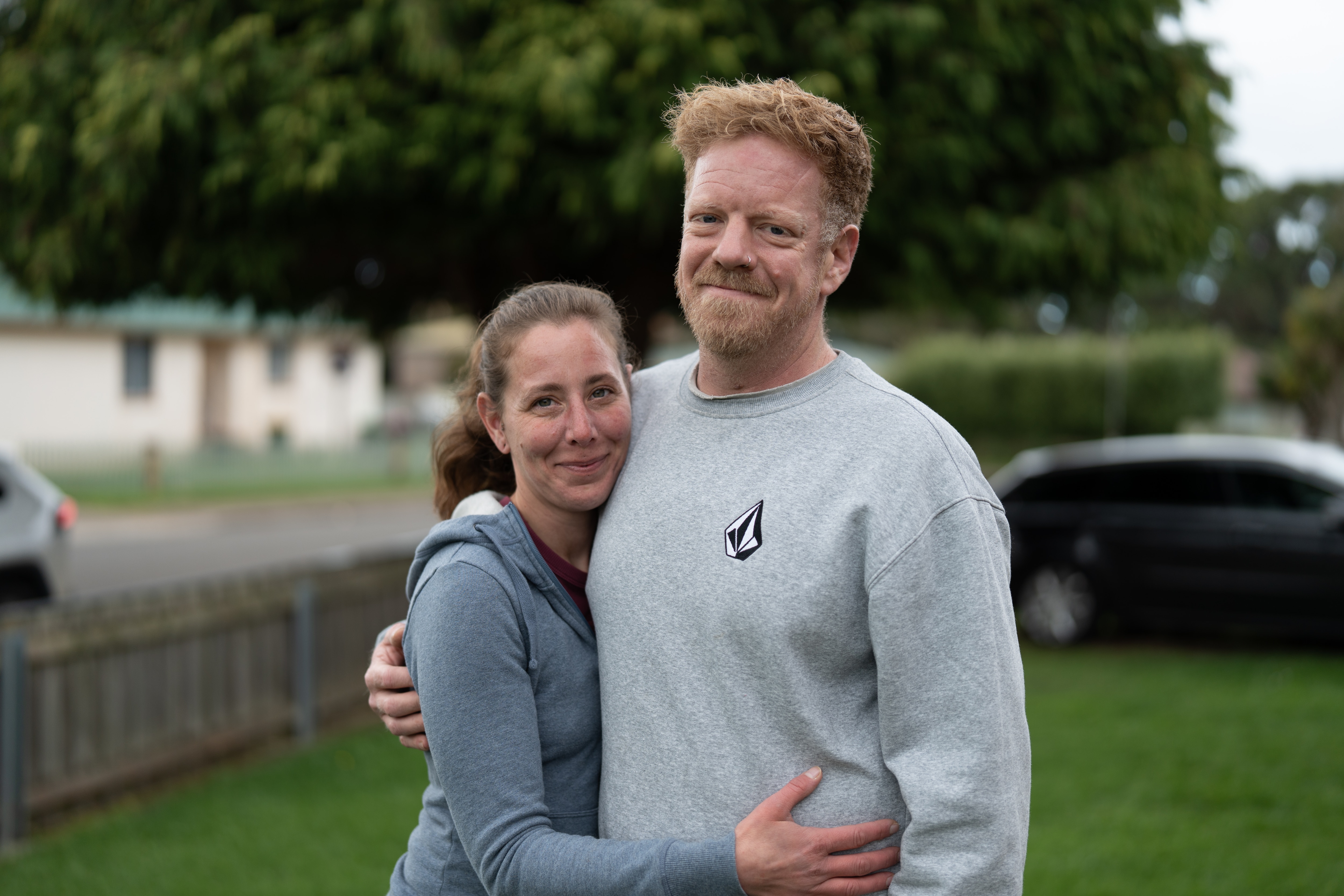 Woman and man stand for portrait in front yard