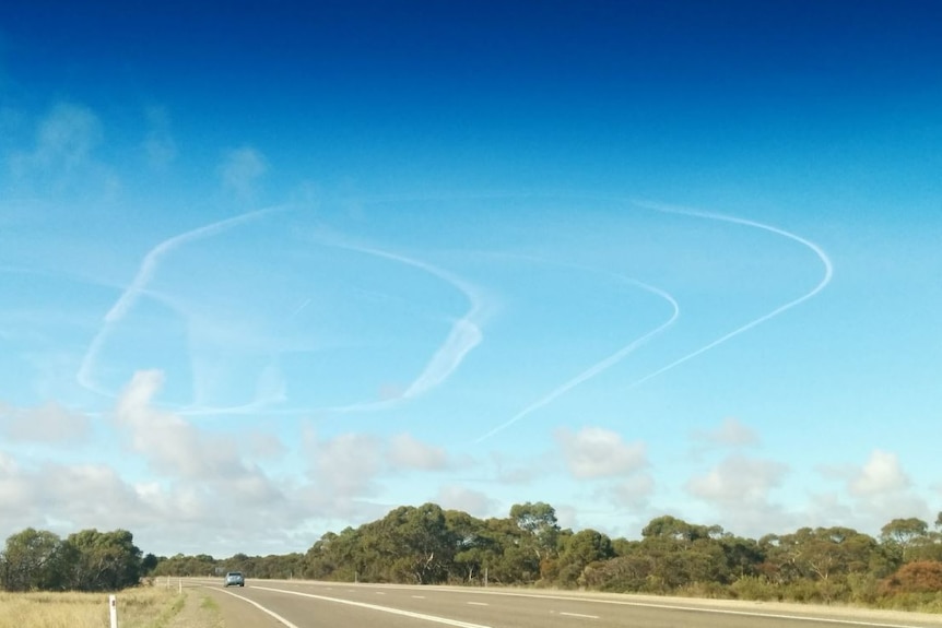 Trails left by three planes circling in the sky due to heavy fog in Adelaide.