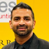 A middle-aged bearded man smiling for the camera.