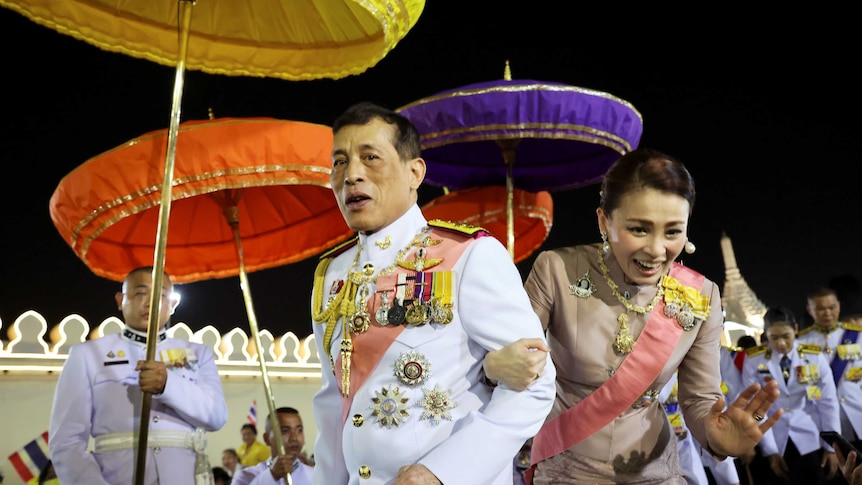 Thailand's King Maha Vajiralongkorn and Queen Suthida greet their royalists as they leave a religious ceremony in Bangkok.