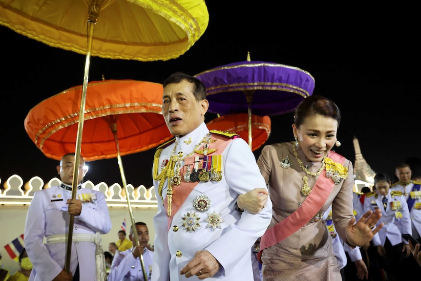 Thailand's King Maha Vajiralongkorn and Queen Suthida greet their royalists as they leave a religious ceremony in Bangkok.