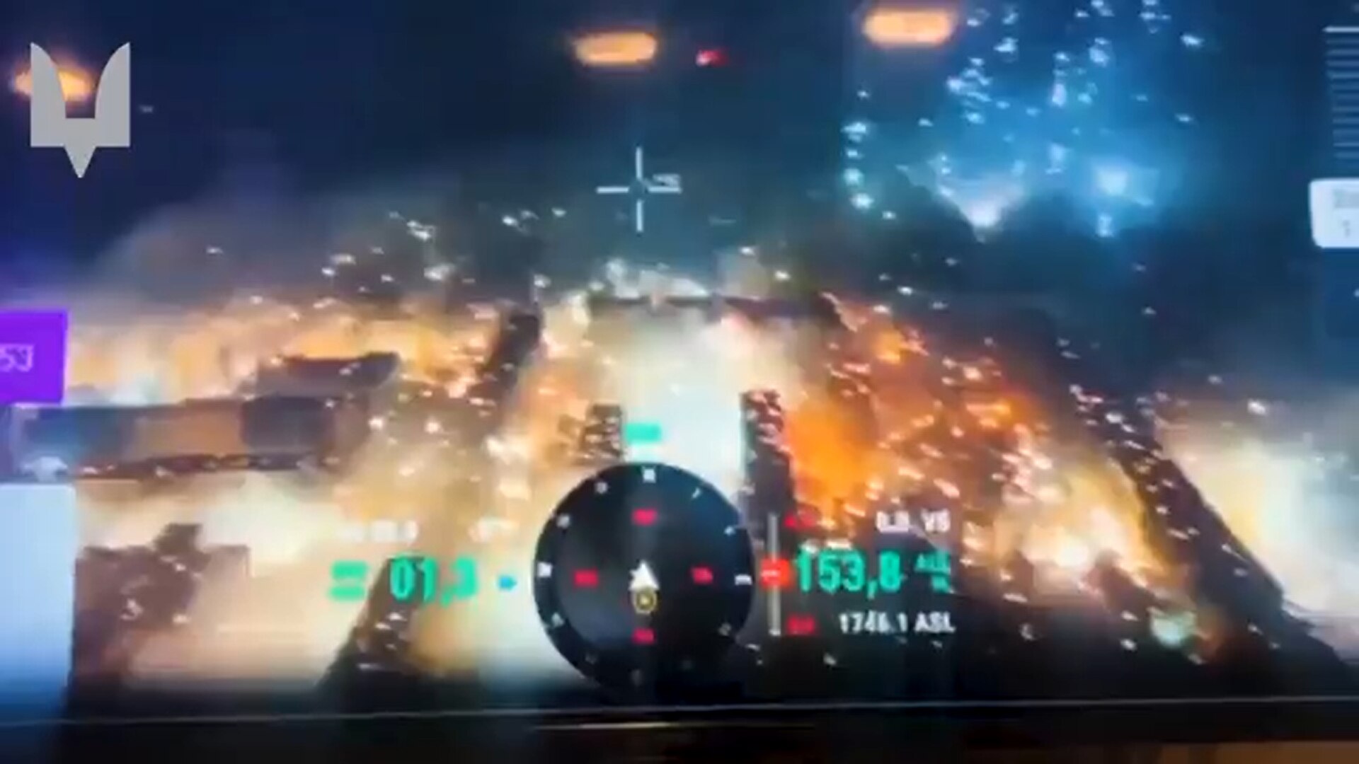 Aerial view of Bakhmut at night, burning as bright white explosions are seen in the sky.