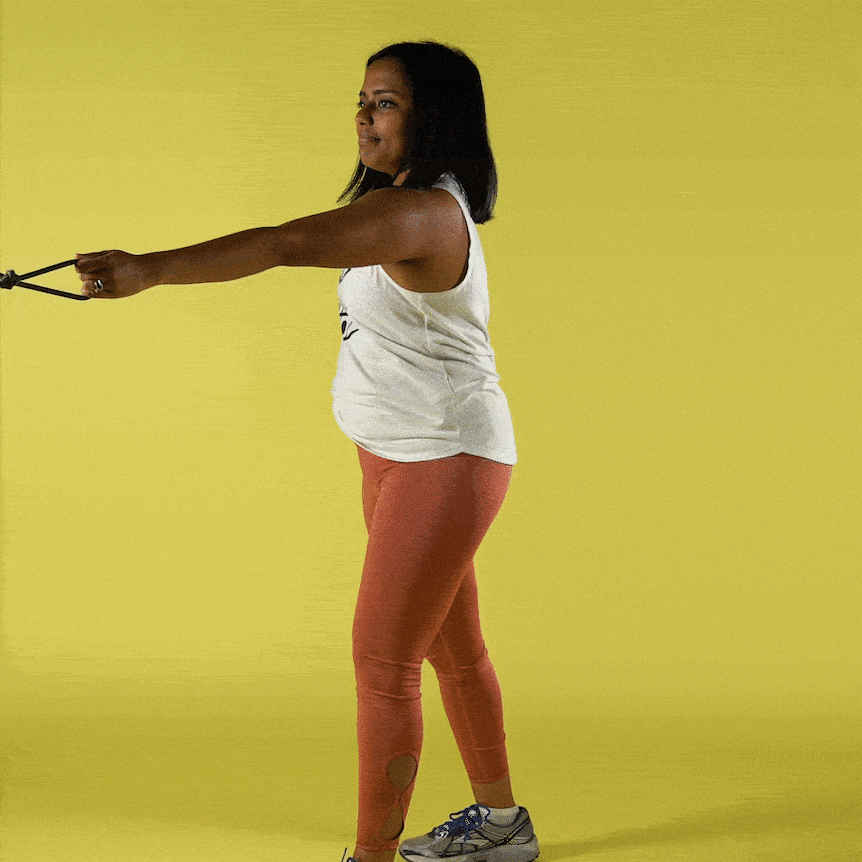 A woman does a single arm row with an exercise band.