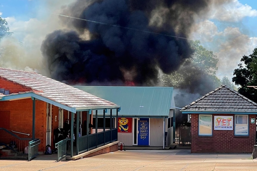 Black smoke billows out of a school.