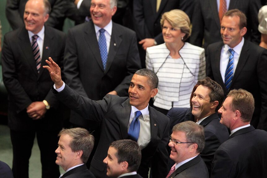 Barack Obama looks up and waves following his address to a special sitting of Federal Parliament. (AAP: Rick Rycroft)