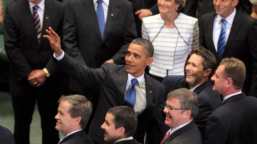Barack Obama looks up and waves following his address to a special sitting of Federal Parliament.