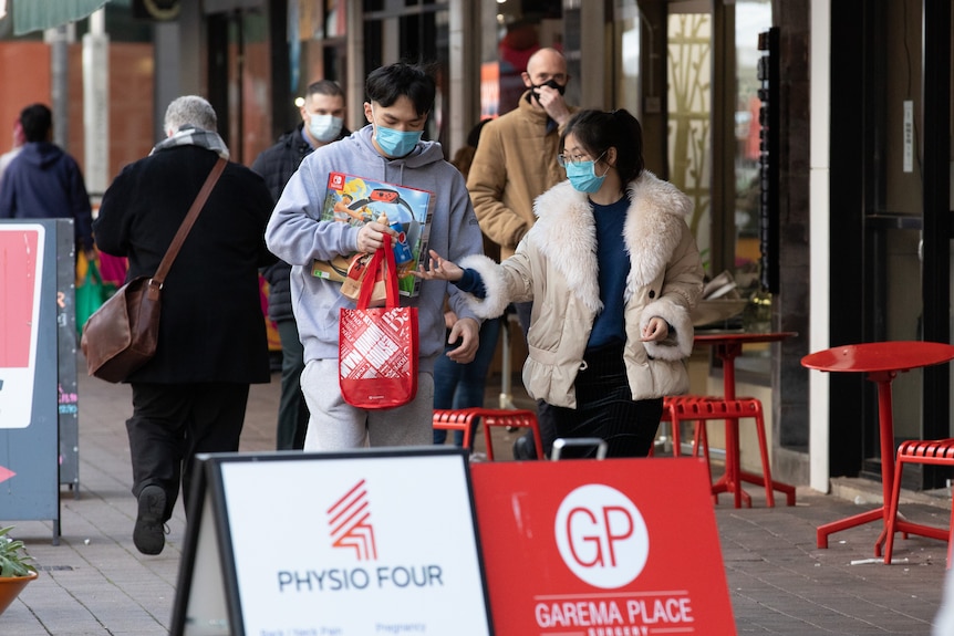 Generic image of people walking through Civic in Canberra wearing masks