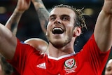 Marching on ... Gareth Bale (C) and Wales celebrate the victory over Belgium