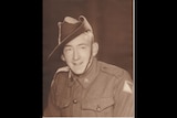 A sepia photo of a young smiling man in army uniform