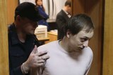 Bolshoi Theatre dancer Pavel Dmitrichenko being led out of court
