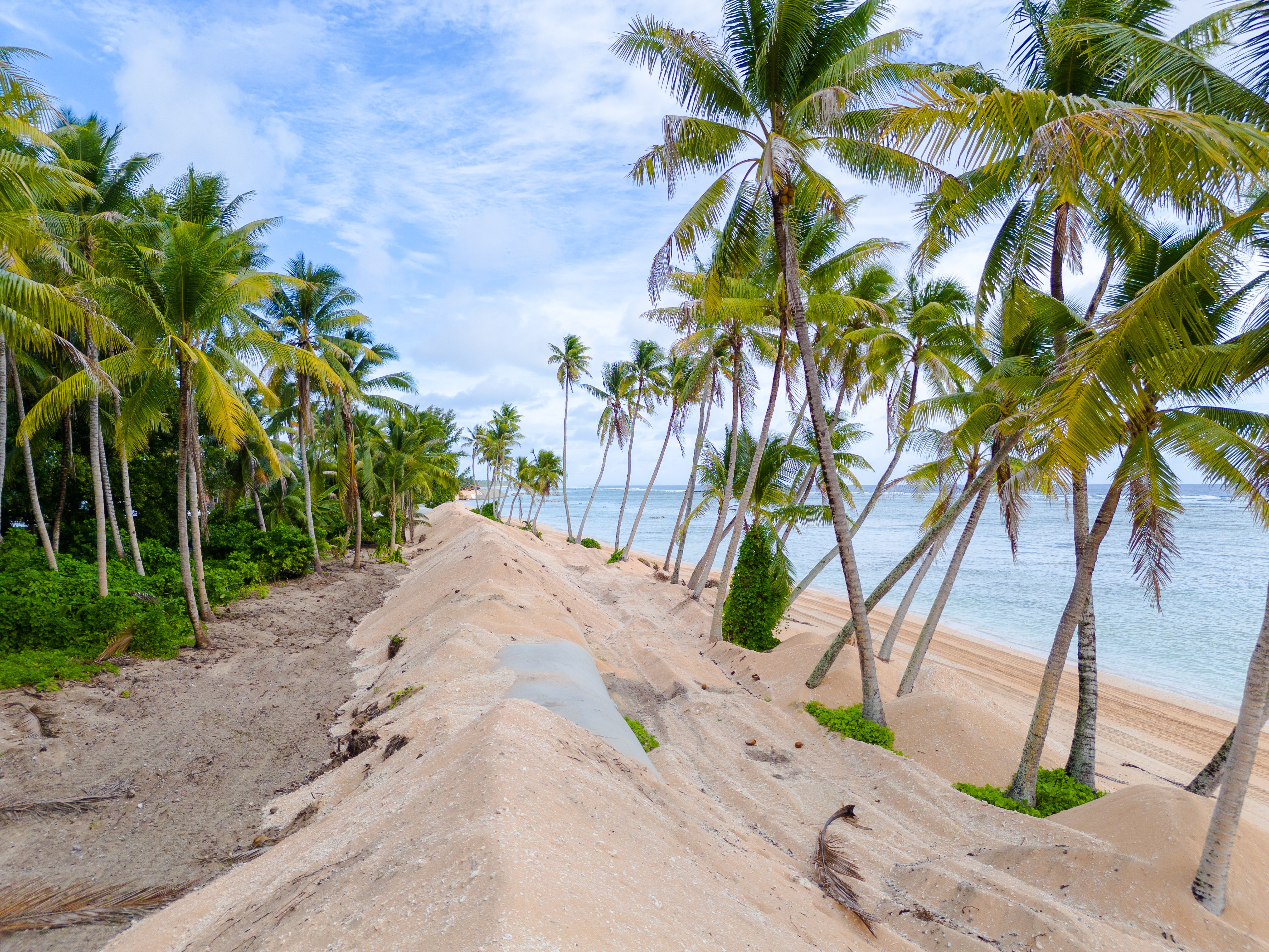 An ocean sand barrier on the reef island of Nanumanga — it's only 3 kilometres square in size with a population less than 400.