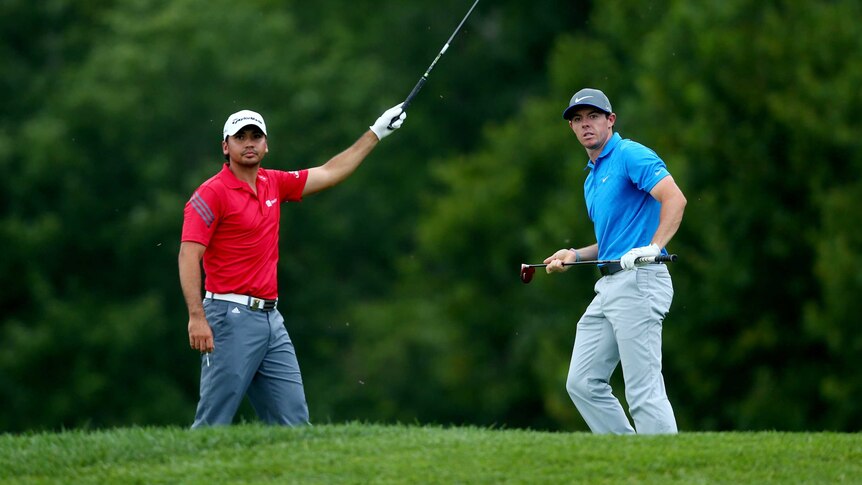 Jason Day and Rory McIlroy signal at the PGA Championship