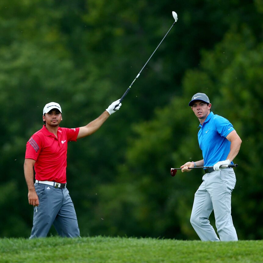 Jason Day and Rory McIlroy signal at the PGA Championship