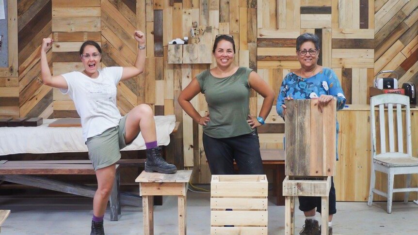 Mother and her two daughters finish making tables.