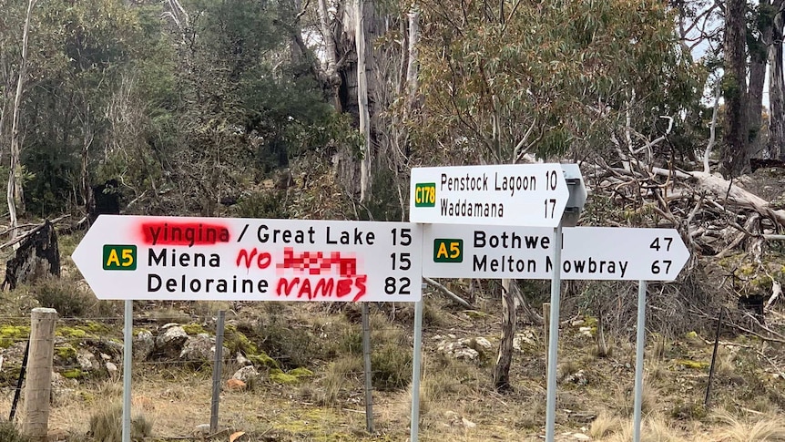 A sign at a road intersection has been vandalised with red spray paint with a racist slur.