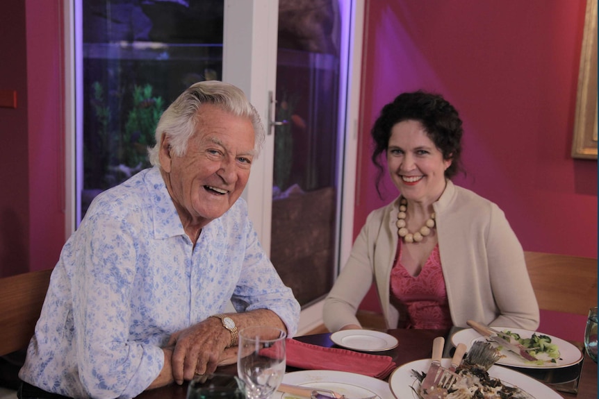 Hawke and Crabb sitting at dinner table.