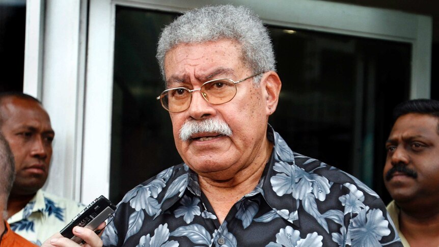 Fiji's former Prime Minister Laisenia Qarase talks to members of the media outside his office, December 2, 2006