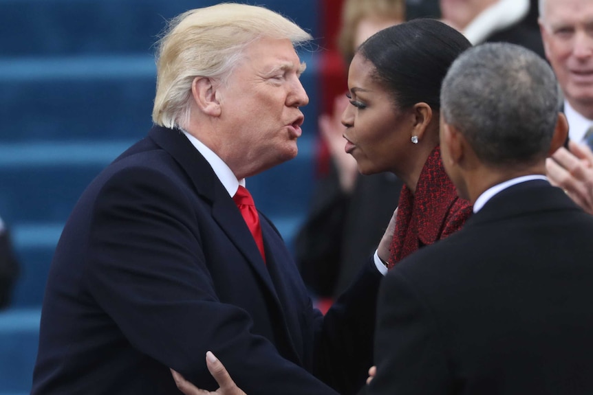 a man and a woman greet each other