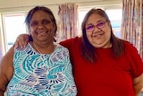 Two Indigenous women smile for the camera.