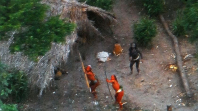 Members of one of the world's last uncontacted tribes fire arrows at the plane flying over their settlement.