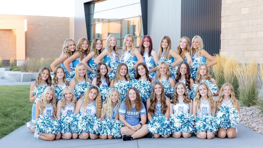 A photo of cheerleaders with Morgyn Arnold sitting front and centre.