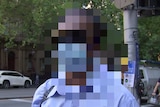 A pixelated image of a man crossing a road.