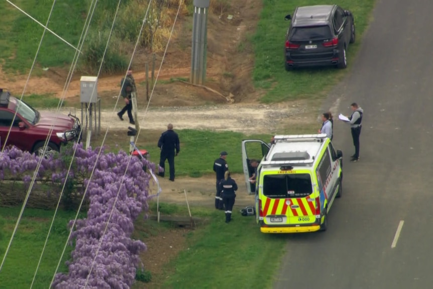 An aerial view of police on a rural street.