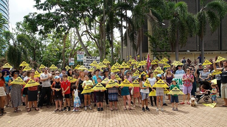 Protesters hold no fracking signs during a rally in Darwin.