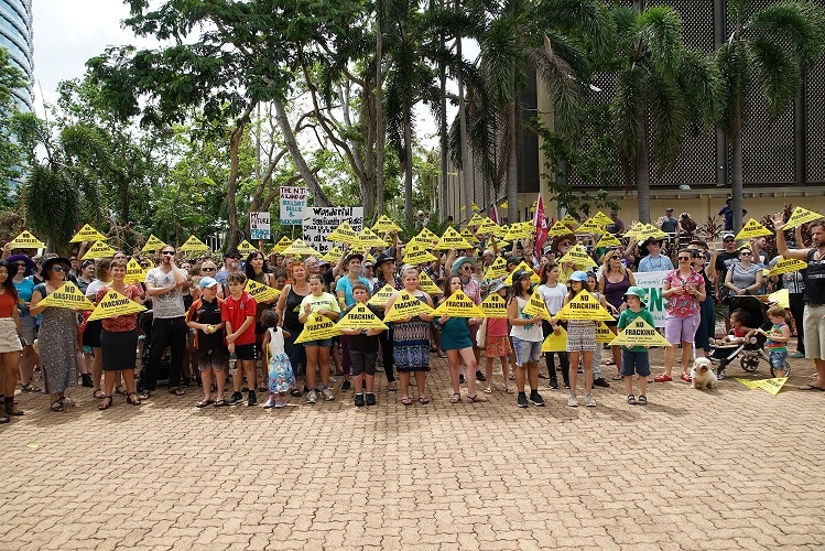 Protesters hold no fracking signs during a rally in Darwin.