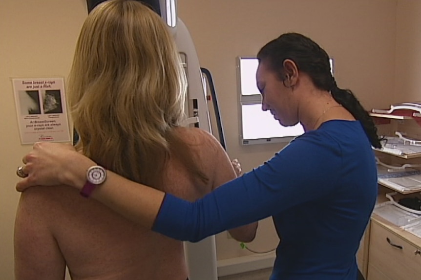 A woman has a mammogram in a doctor's clinic