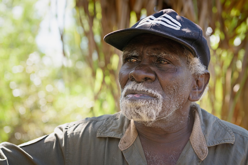 Peter Djiggirr looks across the camera from close range in the bush near Ramingining.