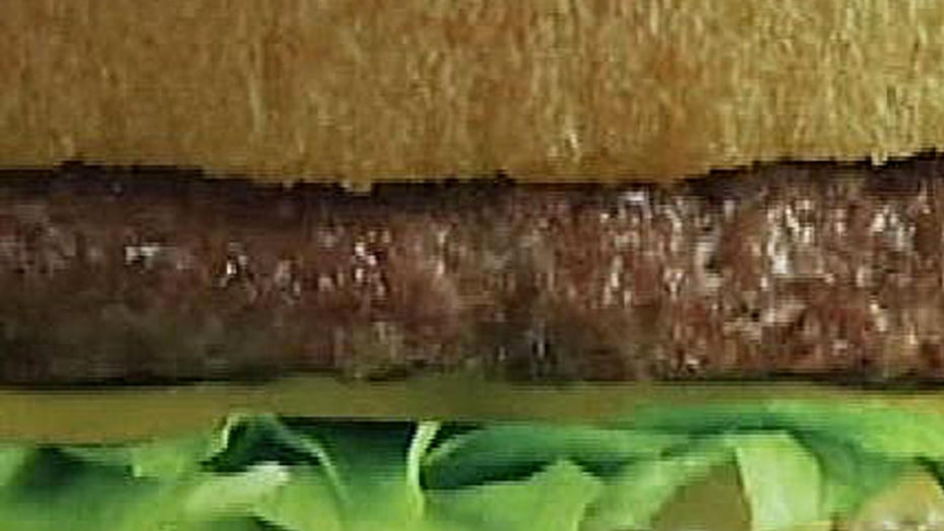 close up of burger with lettuce and beef patty
