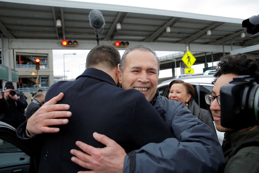Iraqi immigrant Hameed Darweesh is embraced after his release.