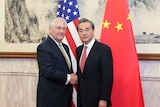 Rex Tillerson shakes hands with Chinese foreign minister Wang Yi (R)