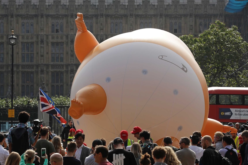 The Trump Baby balloon lays on its back. It is depicted wearing a diaper.