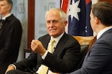 Prime Minister Malcolm Turnbull, seated next to moderator, speaks during a question and answer session.