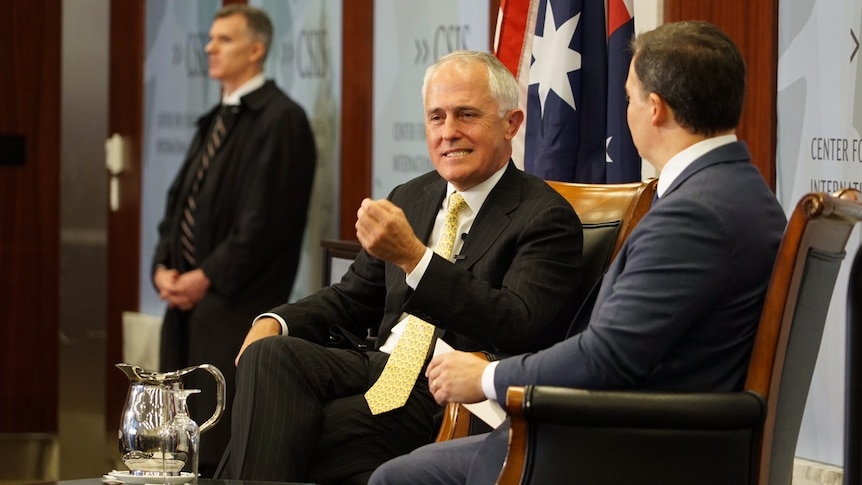 Prime Minister Malcolm Turnbull, seated next to moderator, speaks during a question and answer session.