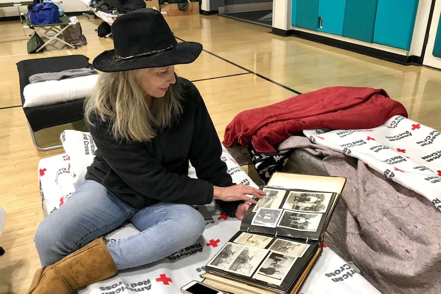 Sheila Johnson looks at old photographs from inside the temporary shelter.