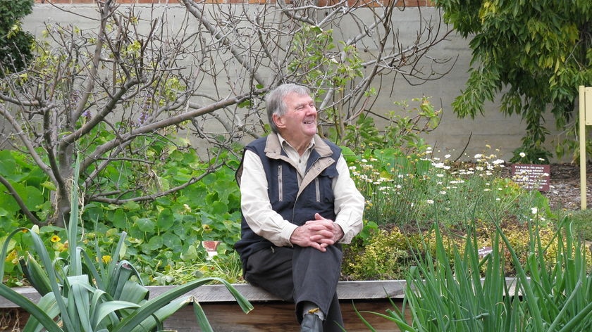 Peter Cundall sitting surrounded by plants